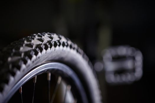 Black rubber tire with spikes for a bicycle wheel. Bike accessories