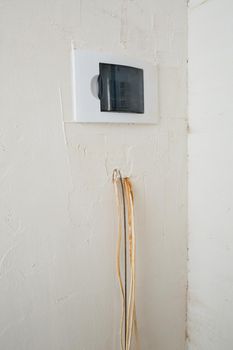 Electricity installation. During repair. open the wires. Sticking out isolated on a white wall. Professional installation electrically