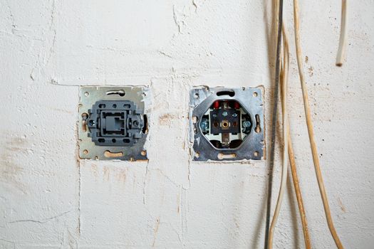 Sockets when mounted without a cover. During repair. open the wires. European nest without cover isolated on a white background. Professional installation of electrical outlets