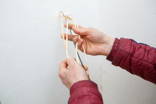 Electricity installation. During repair. open the wires. Sticking out isolated on a white wall. Professional installation electrically