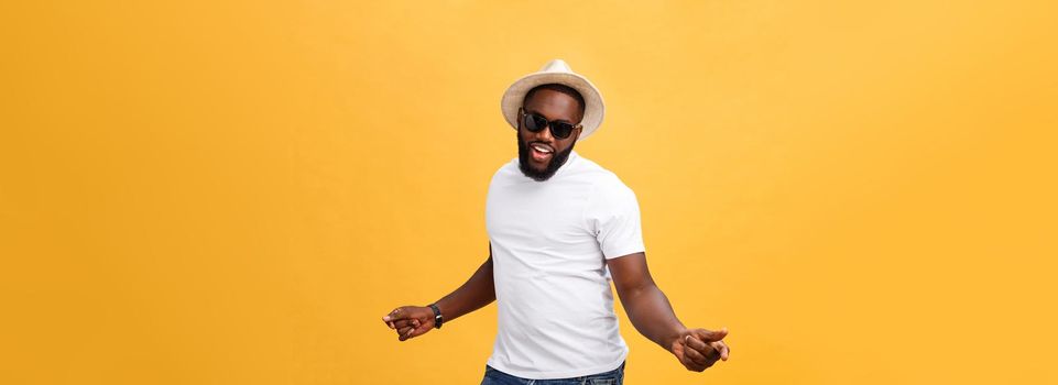 Young black man top dancing isolated on a yellow background