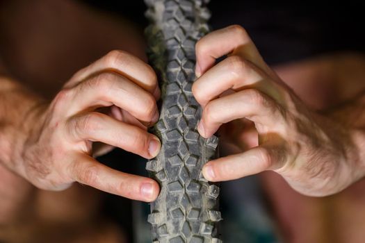 A man changes the camera on a bicycle wheel. Spike Bike Chamber