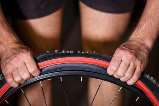 A man changes the camera on a bicycle wheel. Spike Bike Chamber