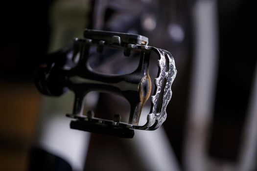 Black metal pedal on a bike with hard light. Bike accessories