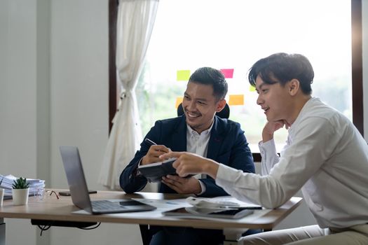 Asian business adviser meeting to analyze and discuss the situation on the financial report in the meeting room.Investment Consultant, Financial advisor and accounting concept.