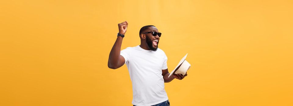 Young black man top dancing isolated on a yellow background