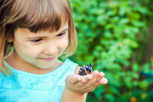 Child with a butterfly. Selective focus. nature and child.