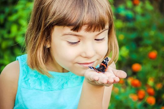 Child with a butterfly. Selective focus. nature and child.