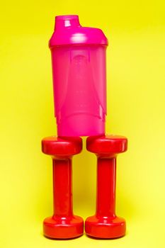 red dumbbells, pink shaker, colored background, sports, energy drink, gym equipment