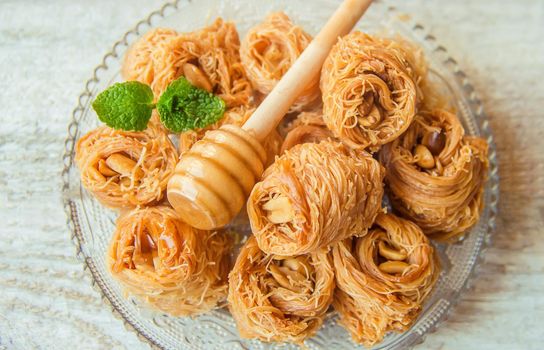 Eastern sweetness, baklava with peanuts and honey. Isolate. Selective focus. Food.