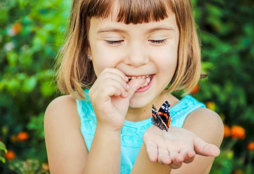 Child with a butterfly. Selective focus. nature and child.