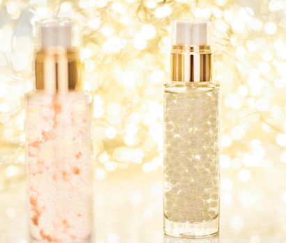 Cosmetic branding, blank label and glamour present concept - Holiday make-up base gel, serum emulsion, lotion bottle and golden glitter, luxury skin and body care cosmetics for beauty brand ads