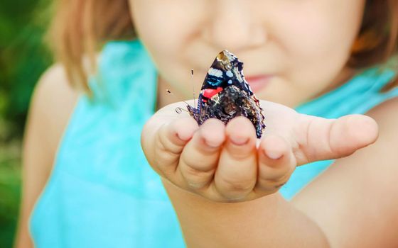 Child with a butterfly. Selective focus. nature and child.