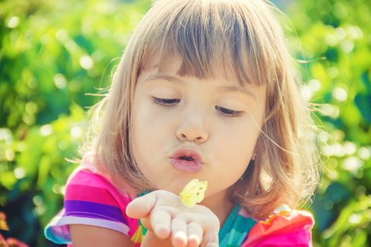 Child with a butterfly. Selective focus. nature and child.