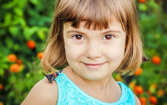 Child with a butterfly. Selective focus. nature and child.