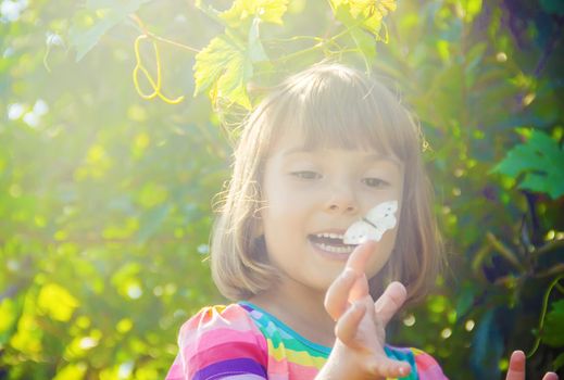 Child with a butterfly. Selective focus. nature and child.