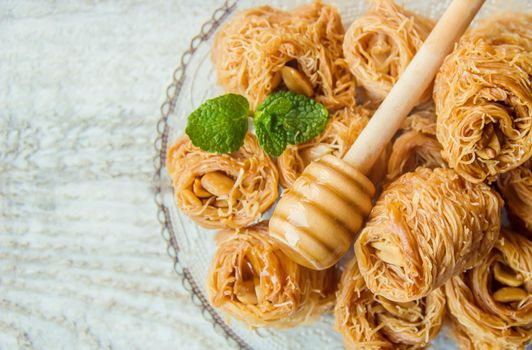 Eastern sweetness, baklava with peanuts and honey. Isolate. Selective focus. Food.