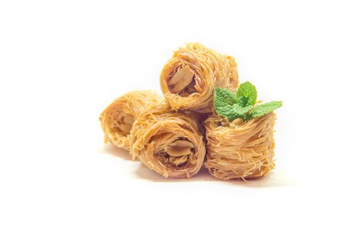 Eastern sweetness, baklava with peanuts and honey. Isolate. Selective focus. Food.
