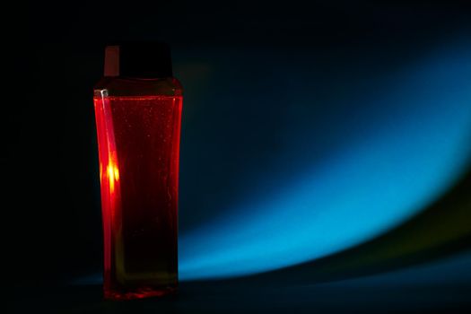 bottle with cream, shampoo for hair, shower gel, colored background, beautiful studio light, beauty and youth of the human body
