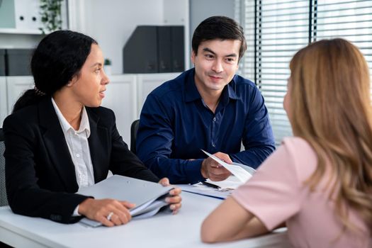 A young female asian candidate tries to impress her interviewer by being competent. International company, multicultural environment in workplace.