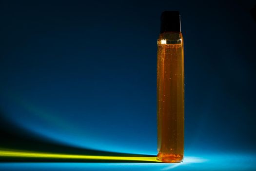 bottle with cream, shampoo for hair, shower gel, colored background, beautiful studio light, beauty and youth of the human body