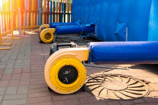 a blower for inflating a large trampoline in the park. Electric Air Blower Pump Fan. High quality photo