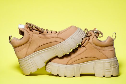 Brown women's leather shoes on a colored background. Fashion trend