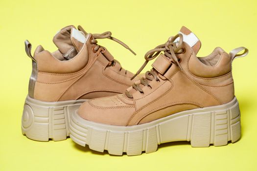 Brown women's leather shoes on a colored background. Fashion trend