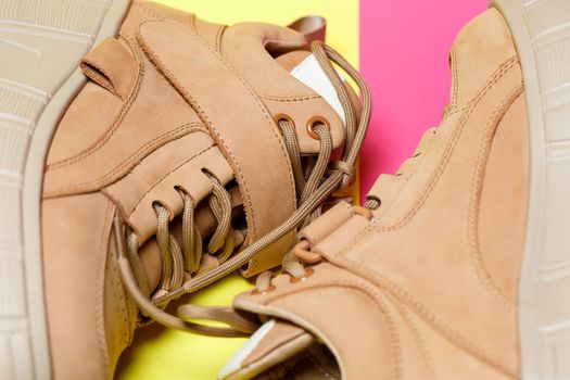 Brown women's leather shoes on a colored background. Fashion trend