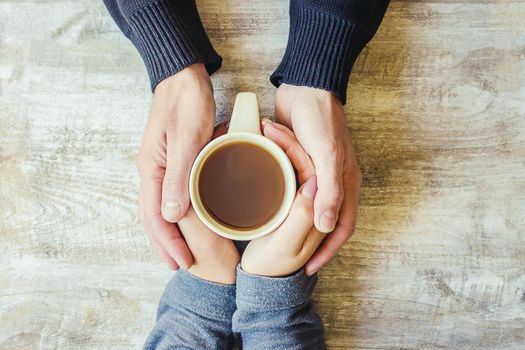 Tea in hand. The lovers are together. Selective focus. Drink.