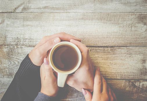 Tea in hand. The lovers are together. Selective focus. Drink.