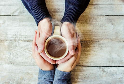 Cup drink for Breakfast in the hands of lovers. Selective focus. Nature.