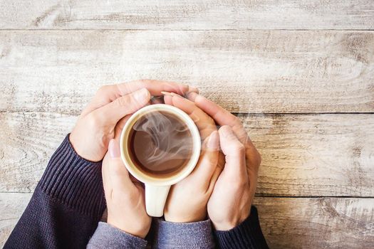 Tea in hand. The lovers are together. Selective focus. Drink.