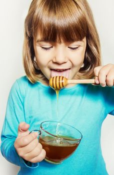 The child eats honey. Selective focus. nature food