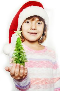 Child holds a Christmas decor and gifts on a white background. Selective focus. Happy.