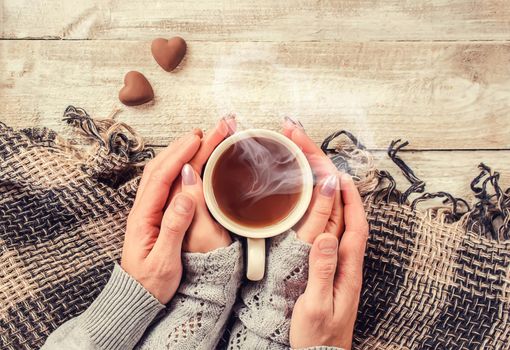 Cup drink for Breakfast in the hands of lovers. Selective focus. Nature.