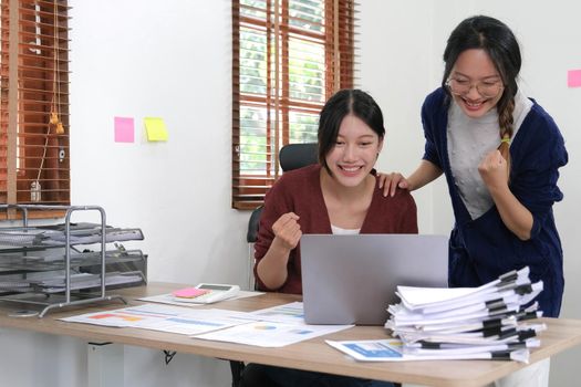 Female smiling colleagues celebrate business win, goal achievement at workplace, giving five, successful teamwork, businesswomen start work with new project, good brainstorm results, victory concept.