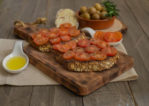 toast bread with cherry tomato and olive oil with rosemary