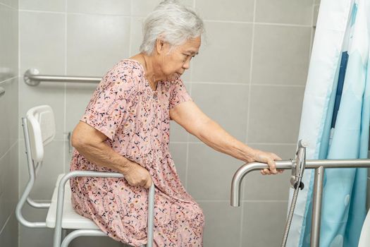 Asian senior or elderly old lady woman patient use toilet bathroom handle security in nursing hospital ward, healthy strong medical concept.