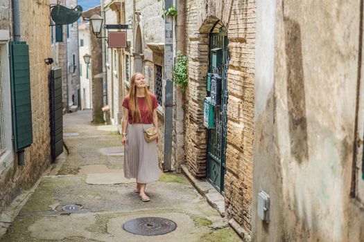 Woman tourist in Herceg Novi old town. Historical and touristic center of Herceg Novi. Montenegro.