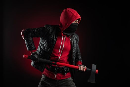 the man in a Balaclava and hoodie with an axe the image of a Protestant