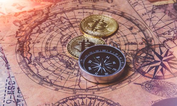 Bitcoin search. Cryptocurrency mining. A pile of coins. Pirate treasure with bitcoin coins. Maps, compass and coin.