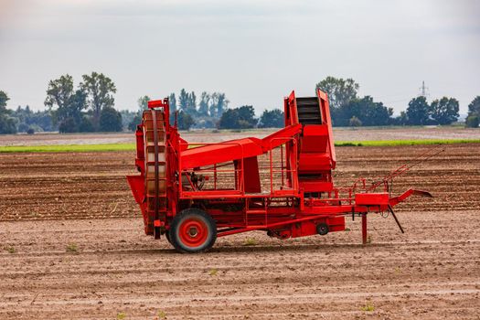 A harvesting machine for harvesting onions in autumn on a field, Germany
