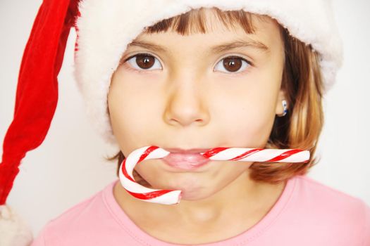 Child holds a Christmas decor and gifts on a white background. Selective focus. Happy.