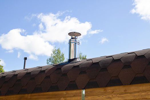 Metal stove pipe on the roof close up