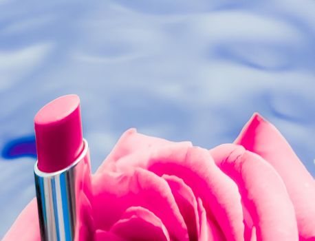 Cosmetic branding, luxe and fashion concept - Pink lipstick and rose flower on liquid background, waterproof glamour make-up and lip gloss cosmetics product for luxury beauty brand holiday design