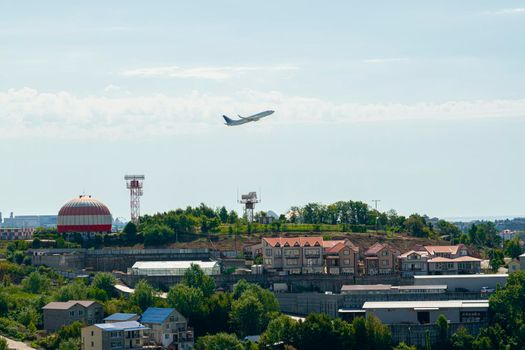 the plane takes off over the weather station and the city. photo