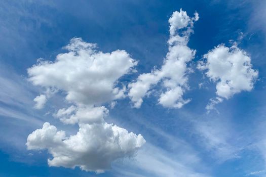 White clouds in blue sky. Beautiful fluffy clouds on blue heaven background
