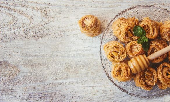 Eastern sweetness, baklava with peanuts and honey. Isolate. Selective focus. Food.