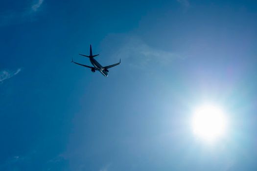 the plane is flying against a background of blue sky and sun. video
